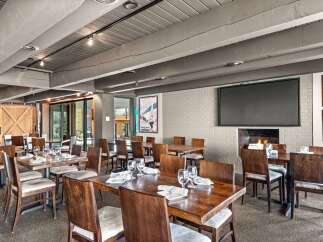 This inviting restaurant space features a warm, rustic ambiance, perfect for a memorable dining experience.