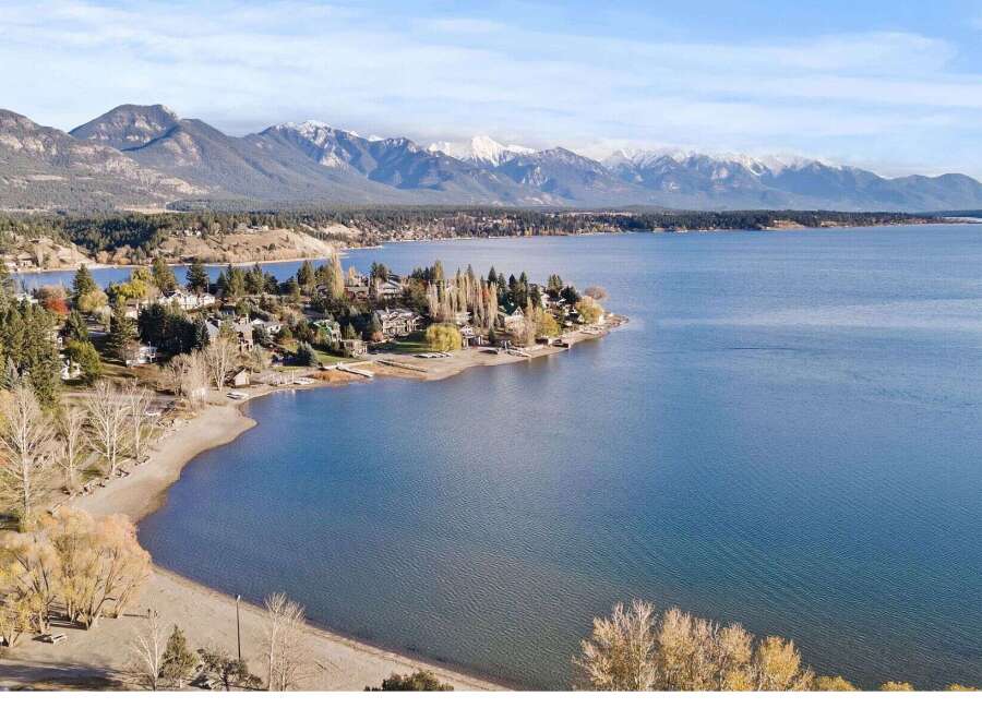 Discover your dream home with stunning lake and mountain views! This property offers a serene escape with a private beach and lush greenery.