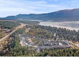 Discover a stunning lakeside property nestled amidst lush greenery and breathtaking mountain views.