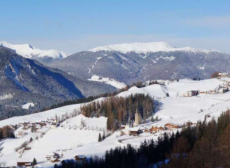 Nestled in a picturesque winter wonderland, this stunning property offers breathtaking views of snow-capped mountains and charming villages.