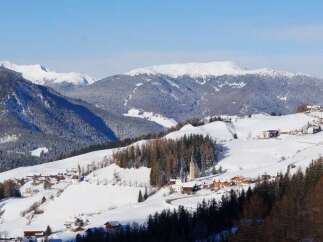 Nestled in a picturesque winter wonderland, this stunning property offers breathtaking views of snow-capped mountains and charming villages.