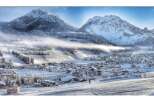 Experience the charm of a winter wonderland in this picturesque village nestled amidst snow-capped mountains.