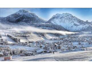 Experience the charm of a winter wonderland in this picturesque village nestled amidst snow-capped mountains.