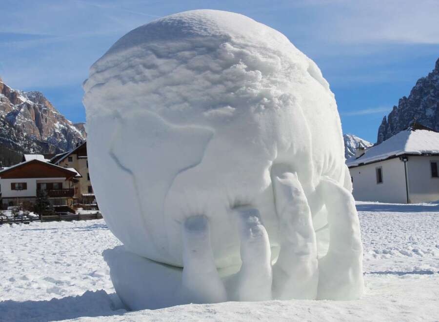 This unique snow sculpture, resembling a hand, is a testament to the creativity found in winter wonderlands.