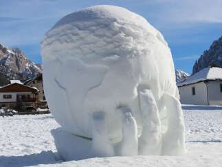 This unique snow sculpture, resembling a hand, is a testament to the creativity found in winter wonderlands.