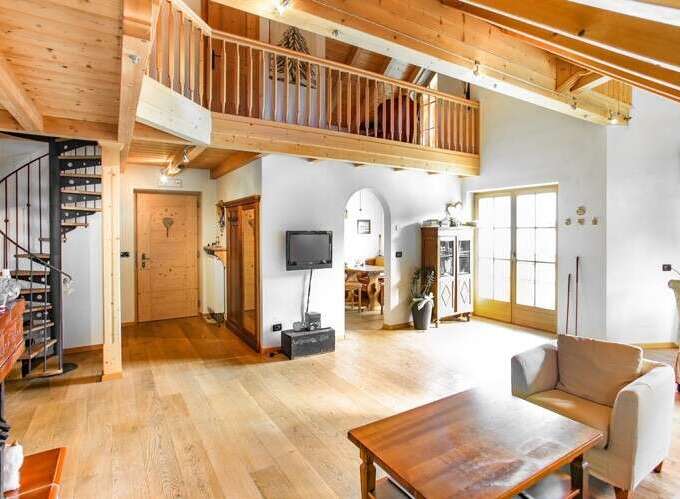 This stunning property boasts a unique architectural design with exposed wooden beams and a charming spiral staircase.