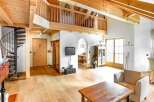This stunning property boasts a unique architectural design with exposed wooden beams and a charming spiral staircase.