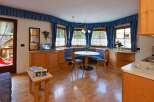 This charming property boasts a cozy dining area with a round table and built-in seating, perfect for intimate gatherings.