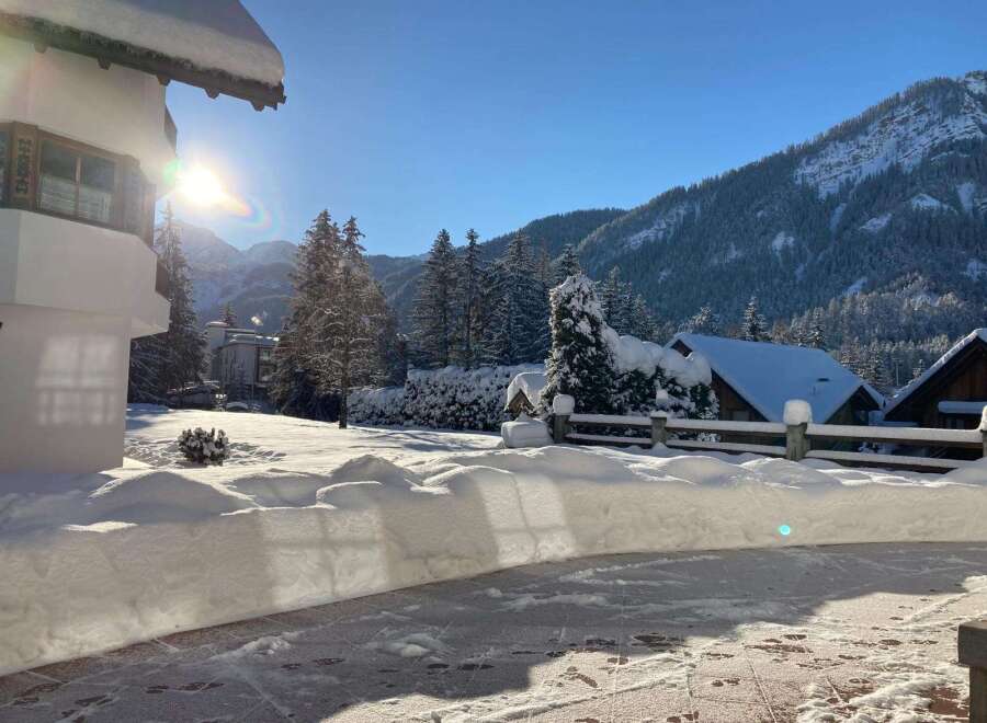 Experience the charm of winter in this stunning property! Nestled amidst a snowy landscape, this home offers breathtaking views of snow-covered mountains and lush evergreen trees.