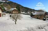 Discover a charming property nestled in a serene winter landscape.