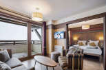 Experience luxury living in this stunning property, featuring a spacious living area with a cozy sofa and a modern TV.