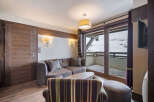 Experience luxury living in this stunning property, featuring a cozy living room with a comfortable sofa and a stylish armchair.