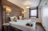 This cozy bedroom features two twin beds with crisp white linens and accent pillows.