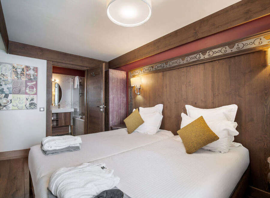 This cozy bedroom features two comfortable beds, perfect for a relaxing stay.
