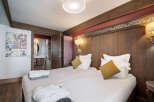 This cozy bedroom features two comfortable beds, perfect for a relaxing stay.