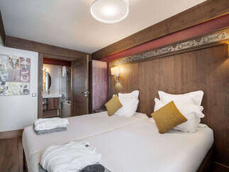 This cozy bedroom features two comfortable beds, perfect for a relaxing stay.