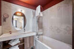 This elegant bathroom features a modern design with a sleek vanity and a stylish mirror.