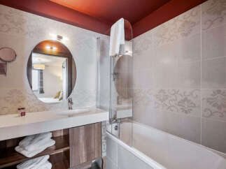 This elegant bathroom features a modern design with a sleek vanity and a stylish mirror.