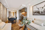 Discover modern living in this stylish apartment, featuring a sleek kitchen and a cozy dining area perfect for entertaining.