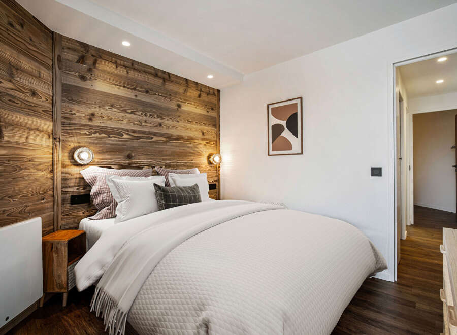 Experience the warmth and charm of this cozy bedroom, featuring a stunning wooden accent wall that adds a touch of rustic elegance.