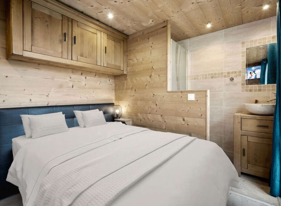 This cozy bedroom features a rustic wooden design, creating a warm and inviting atmosphere.