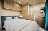 This cozy bedroom features a rustic wooden design, creating a warm and inviting atmosphere.