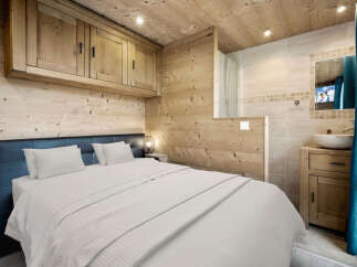 This cozy bedroom features a rustic wooden design, creating a warm and inviting atmosphere.