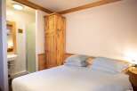 This charming bedroom offers a cozy and inviting atmosphere, perfect for a relaxing getaway.