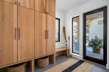 This stunning entryway showcases a custom wooden storage unit, perfect for organizing gear.