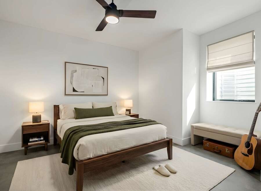 This inviting bedroom features a modern design with clean lines and a neutral color palette, creating a serene and relaxing atmosphere.