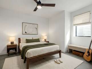 This inviting bedroom features a modern design with clean lines and a neutral color palette, creating a serene and relaxing atmosphere.
