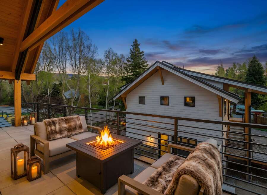 Enjoy the ultimate outdoor living experience with this stunning property! Featuring a cozy fire pit, comfortable seating, and a beautiful view, this space is perfect for entertaining or relaxing.