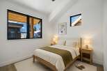 This cozy bedroom features a modern design with a touch of warmth.