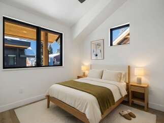 This cozy bedroom features a modern design with a touch of warmth.