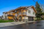 Experience modern living in this stunning multi-level home featuring a sleek exterior with natural wood accents and stone detailing.
