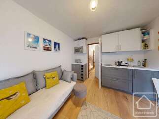 Discover this charming property featuring a cozy living area with a comfortable sofa and decorative pillows.