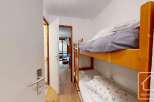 This cozy bedroom features a charming bunk bed, perfect for accommodating guests or family members.