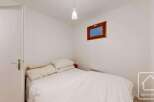 This cozy bedroom features a comfortable bed with soft bedding, perfect for a relaxing retreat.