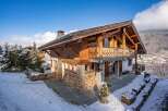 This stunning chalet boasts a beautiful wooden exterior and a cozy, inviting atmosphere.