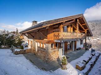 This stunning chalet boasts a beautiful wooden exterior and a cozy, inviting atmosphere.