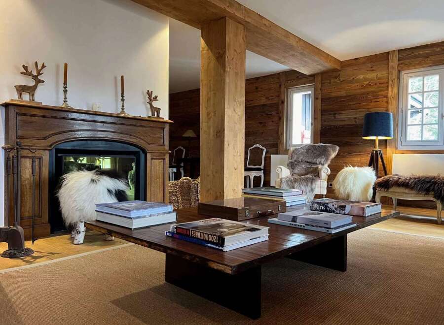 Experience the epitome of luxury living in this stunning property, featuring a cozy fireplace and elegant wooden accents throughout.