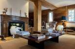 Experience the epitome of luxury living in this stunning property, featuring a cozy fireplace and elegant wooden accents throughout.
