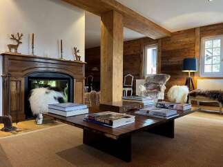 Experience the epitome of luxury living in this stunning property, featuring a cozy fireplace and elegant wooden accents throughout.