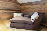 This cozy space features a comfortable chaise lounge, perfect for relaxing.