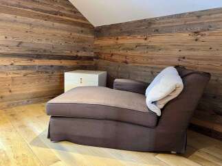 This cozy space features a comfortable chaise lounge, perfect for relaxing.