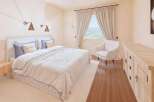 This inviting bedroom boasts a serene atmosphere, perfect for relaxation.
