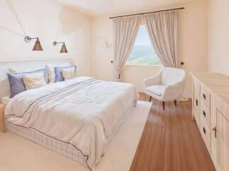 This inviting bedroom boasts a serene atmosphere, perfect for relaxation.