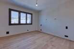Discover the charm of this inviting room, featuring a stunning view through the large windows.