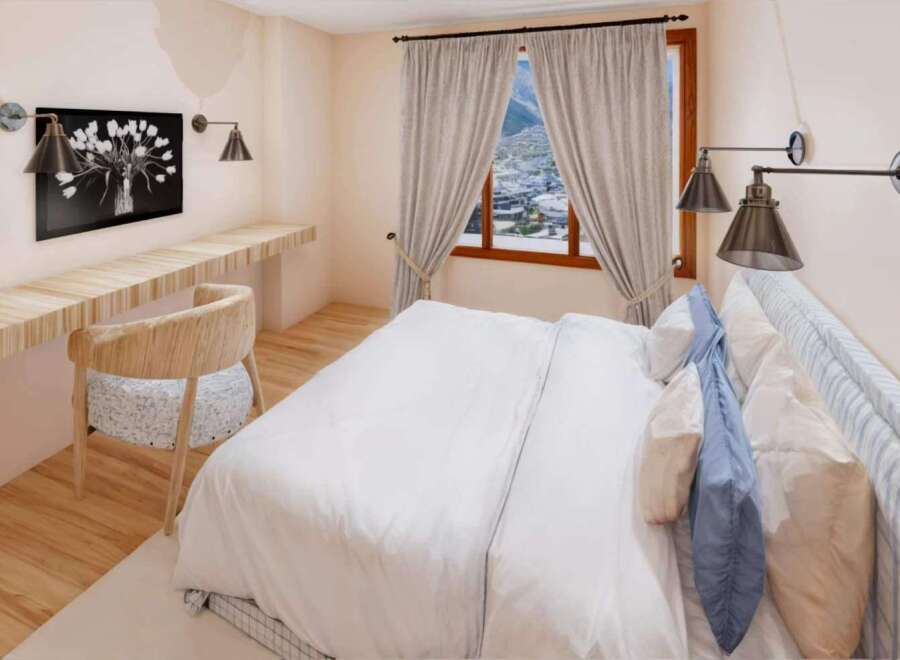 Step into this cozy bedroom, featuring a stylish desk area perfect for work or relaxation.