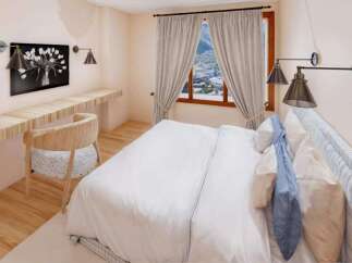 Step into this cozy bedroom, featuring a stylish desk area perfect for work or relaxation.